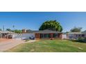 Charming single-story brick home featuring a well-manicured lawn and a cozy front entrance, offering classic curb appeal at 1909 E Bethany Home Rd, Phoenix, AZ 85016