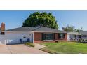 Charming home features a brick facade, manicured lawn, and an inviting, well-maintained exterior at 1909 E Bethany Home Rd, Phoenix, AZ 85016