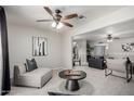 Open living space boasts comfortable seating and modern artwork, perfect for relaxation at 19685 N Star Ridge Dr, Sun City West, AZ 85375