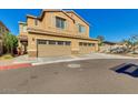 Inviting two-story home featuring a two-car garage and charming curb appeal with desert landscaping at 2254 E University Dr # 4, Mesa, AZ 85213
