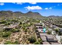 Aerial view of a neighborhood surrounded by mountains and desert landscape on a sunny day at 2638 W Sat Nam Way, Phoenix, AZ 85086