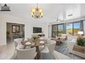 Virtually staged dining room with a round table, living room area, and bright natural light at 2638 W Sat Nam Way, Phoenix, AZ 85086