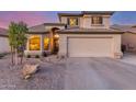 Inviting two-story home features a desert-landscaped front yard, arched entryway, and a two-car garage, enhancing curb appeal at 3031 S Cortland --, Mesa, AZ 85212