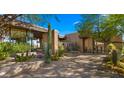 This home features desert landscaping, stone walls, and modern windows with beautiful views at 30600 N Pima Rd # 61, Scottsdale, AZ 85266