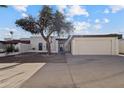 Welcoming single-story home with a secure gated entrance and convenient attached garage at 3218 W Clinton St, Phoenix, AZ 85029