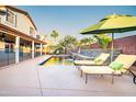 Relax by the refreshing pool with comfortable lounge chairs, verdant foliage, and a lovely rock waterfall feature at 3597 W Mineral Butte Dr, San Tan Valley, AZ 85144