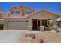 Charming two-story home featuring a covered porch, desert landscaping, and a two car garage at 42812 W Venture Rd, Maricopa, AZ 85138