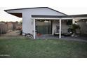 Enjoy outdoor living with this covered patio including a TV, and comfortable seating at 4755 E Gary St, Mesa, AZ 85205