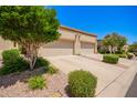 Driveway leading up to garages, framed by desert landscaping under a bright, sunny sky at 6730 E Hermosa Vista Dr # 72, Mesa, AZ 85215