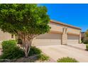 Driveway leading up to garages, framed by desert landscaping under a bright, sunny sky at 6730 E Hermosa Vista Dr # 72, Mesa, AZ 85215