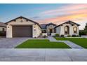 Beautifully landscaped single-story home with a paved driveway and neutral colored facade, and a two car garage at 7415 W Lisbon Ln, Peoria, AZ 85381