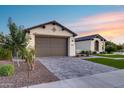 Inviting home exterior with manicured landscaping, a two car garage, and paved driveway, creating curb appeal at 7415 W Lisbon Ln, Peoria, AZ 85381
