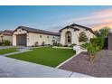 Charming single-story home with a manicured lawn, paved driveway, and inviting entrance and a two car garage at 7415 W Lisbon Ln, Peoria, AZ 85381