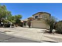 Charming two-story home featuring a tile roof, desert landscaping, and a two-car garage at 7817 S 46Th Dr, Laveen, AZ 85339
