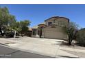 Charming two-story home featuring a tile roof, desert landscaping, and a two-car garage at 7817 S 46Th Dr, Laveen, AZ 85339