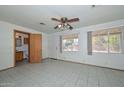 Bright bedroom features tile floors, ceiling fan, and backyard access at 829 E Echo Ln, Phoenix, AZ 85020