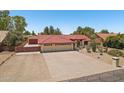 Desert landscaped home features a 3-car garage and long driveway at 8511 W Via Montoya Dr, Peoria, AZ 85383