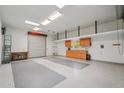 Large garage has epoxy floors, storage, and a work sink with good lighting at 8511 W Via Montoya Dr, Peoria, AZ 85383