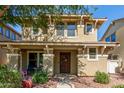 Inviting two-story home with a covered front porch and walkway leading to the entrance at 942 S Deerfield Ln, Gilbert, AZ 85296