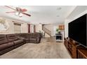 Spacious living room with carpet flooring, ceiling fan, and a comfortable sectional sofa at 942 S Deerfield Ln, Gilbert, AZ 85296