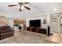Open-concept living area featuring neutral walls, carpet, and a large entertainment center at 942 S Deerfield Ln, Gilbert, AZ 85296