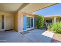 Covered patio featuring privacy wall and exterior access at 10513 W Roundelay Cir, Sun City, AZ 85351