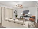 Staged living room area with neutral colored sofa and side chair plus decorative rug at 10610 S 48 St # 1068, Phoenix, AZ 85044