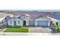 Aerial view of a single-Gathering home with a tile roof and paver driveway in a quiet neighborhood at 10643 E Tumbleweed Ave, Mesa, AZ 85212