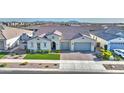 Aerial view of home with two-car garage, tile roof, and meticulous landscaping in suburban neighborhood at 10643 E Tumbleweed Ave, Mesa, AZ 85212