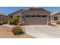 Charming beige single-story home with a spacious two-car garage and desert landscaping at 12132 W Caribbean Ln, El Mirage, AZ 85335