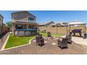 Inviting backyard features a fire pit, above-ground pool, grill, and gazebo, creating a perfect outdoor oasis at 19771 W Woodlands Ave, Buckeye, AZ 85326