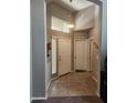 Welcoming foyer with tile floors, neutral colors, and natural light creates an inviting entrance at 21280 N 96Th Ave, Peoria, AZ 85382