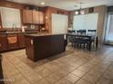 Open kitchen with island and breakfast nook that's great for gatherings and everyday living at 21280 N 96Th Ave, Peoria, AZ 85382