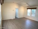 Bright living room showcasing vaulted ceiling, wood-style flooring, and natural light at 2206 S Ellsworth Rd # 1736, Mesa, AZ 85209