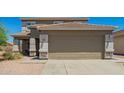 Spacious two-car garage and wide driveway, with stone accents around the posts at 22610 W Mohave St, Buckeye, AZ 85326
