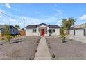 Charming single-story home with a red front door, xeriscape yard, and a walkway leading to the entrance at 2402 N 15Th St, Phoenix, AZ 85006