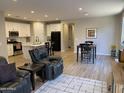 Open-concept living space with tile flooring, a modern kitchen, a dining area, and comfortable seating at 25657 N 185Th Dr, Surprise, AZ 85387