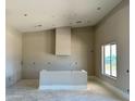 Bright and airy kitchen space with a modern hood and plenty of room for appliances and customization at 25927 N 149Th Dr, Surprise, AZ 85387