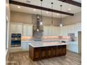 Gorgeous kitchen featuring custom cabinets, stainless steel appliances, and a large center island at 25927 N 149Th Dr, Surprise, AZ 85387