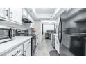 Bright kitchen features modern appliances, white cabinets and plenty of counter space at 2615 N Hayden Rd # 114, Scottsdale, AZ 85257