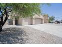 Inviting home with a three-car garage, long driveway, and low-maintenance desert landscaping at 30268 W Sheila Ln, Buckeye, AZ 85396