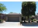 Charming single-story home with a tile roof, desert landscaping, and an attached two-car garage at 34464 N 68Th Way, Scottsdale, AZ 85266