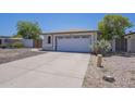 A one-story home exterior features a two car garage, simple xeriscape and a concrete driveway at 3701 W Villa Maria Dr, Glendale, AZ 85308