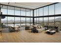 Bright, modern living room features floor-to-ceiling windows with mountain views at 39307 N Silver Saddle Dr, Carefree, AZ 85377