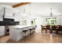 Bright and airy kitchen featuring an island with a quartz countertop, counter seating, and wood floors with a dining area at 4125 N 64Th St, Scottsdale, AZ 85251