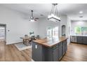 Spacious kitchen seamlessly connects to the dining area, featuring modern appliances and a stylish dining table at 4344 W Kimberly Way, Glendale, AZ 85308