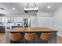 Modern kitchen featuring stainless steel appliances, white cabinets, and a large kitchen island with seating at 4344 W Kimberly Way, Glendale, AZ 85308
