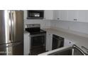 Well-equipped kitchen with stainless steel appliances, white cabinets, and efficient layout for cooking at 4465 E Paradise Village S Pkwy # 1200, Phoenix, AZ 85032