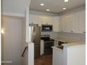 Bright kitchen featuring stainless steel appliances, white cabinetry and countertops with modern recessed lighting at 4465 E Paradise Village S Pkwy # 1200, Phoenix, AZ 85032