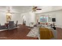 Bright living room with lots of seating, light-colored walls, hardwood floor, and a ceiling fan at 6035 N 9Th Ave, Phoenix, AZ 85013